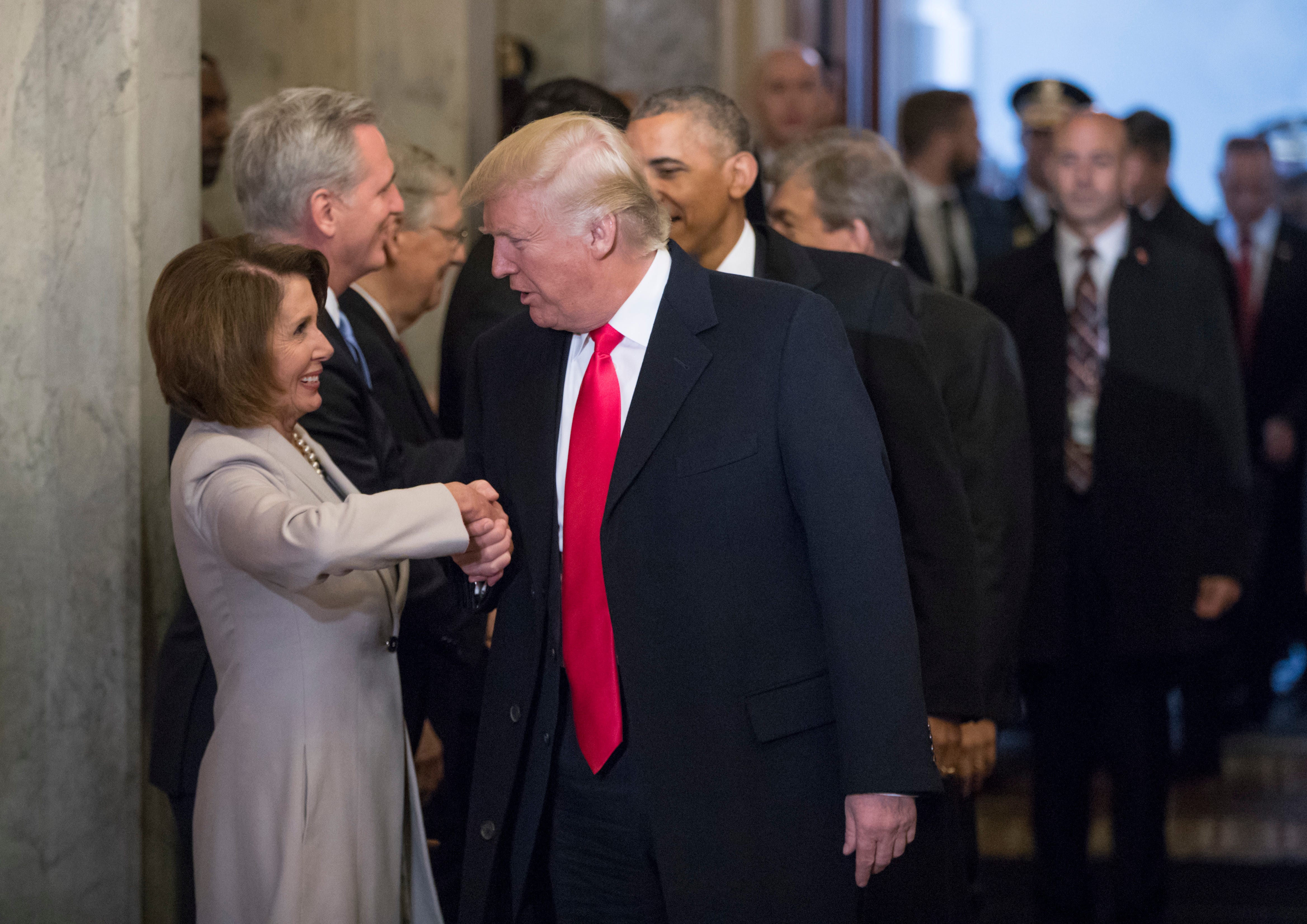 In this 2017 photo, then-President-elect Donald Trump greets House Democratic leader Nancy Pelosi.