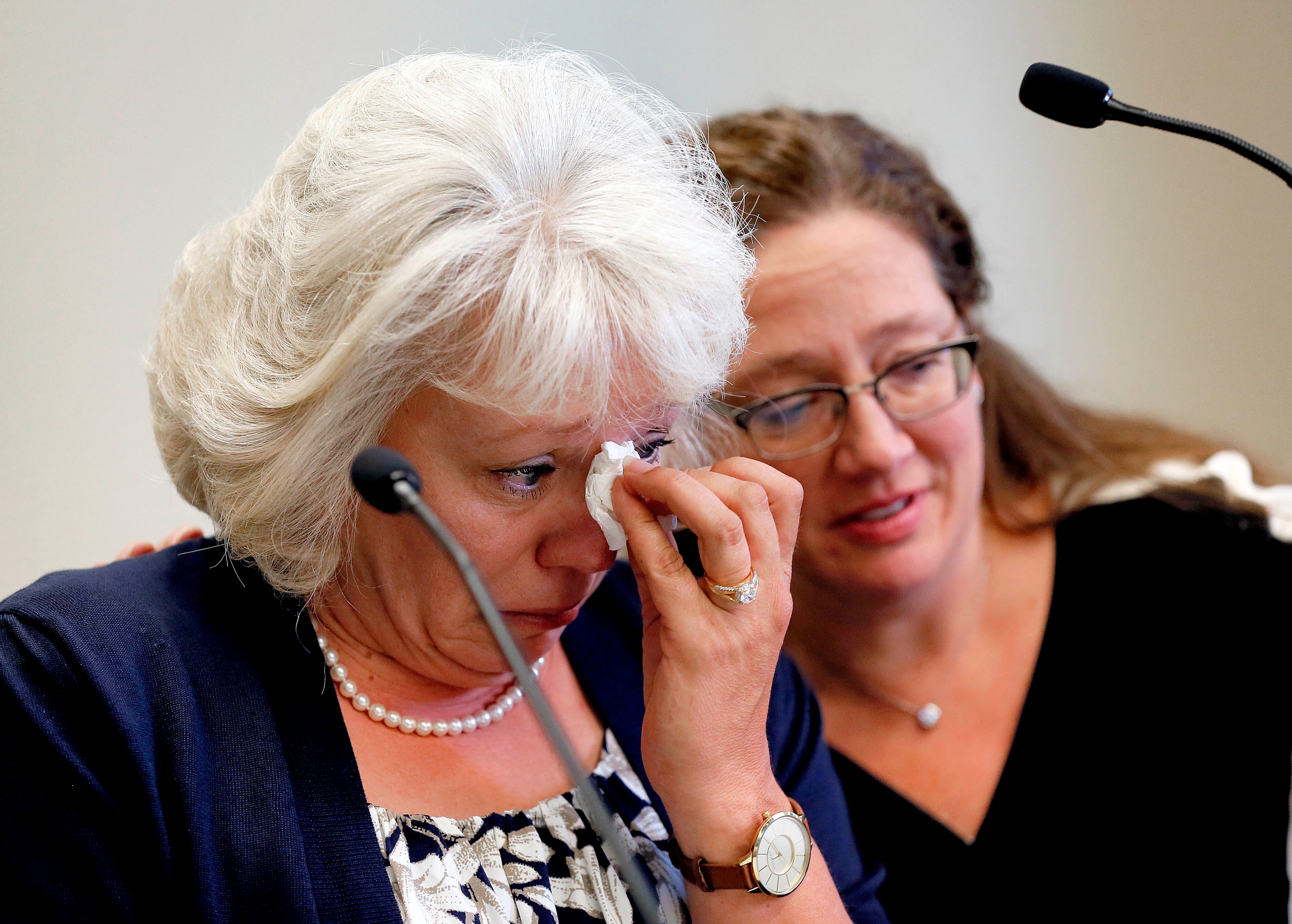 Debra Milke cries as she is embraced by Attorney Lori Voepel, right, during a news conference, March 24, 2015, Phoenix. Milke spoke out for the first time after spending two decades on death row in the killing of her son. In 2013,  Milke was freed after 25 years in prison.