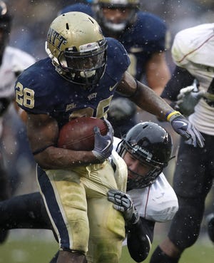 University of Pittsburgh'sDion Lewis, 28, breaks a tackle by University of Cincinnati's Brad Jones to score a touchdown during the fourth quarter of their game played at Heinz Field in Pittsburgh, Pennsylvania Saturday December 5, 2009. UC won 45-44.