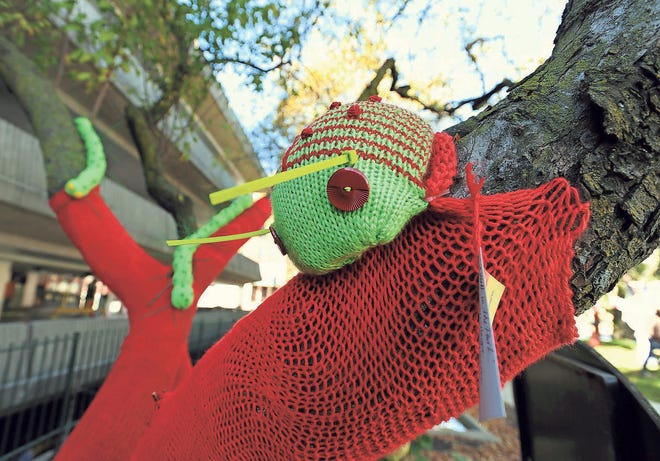 This knitted bug perches on a red yarn-covered tree, one of several trees wrapped and adorned with creatures of all sorts in a park in Birmingham in 2012.