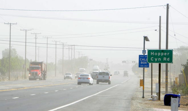 Westbound vehicles face flying dust and debris on Thursday as winds pick up, raising the danger of wildfires and leading to power outages both planned and unplanned.