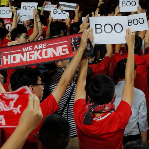 Hong Kong soccer fans turn their back and boo the 