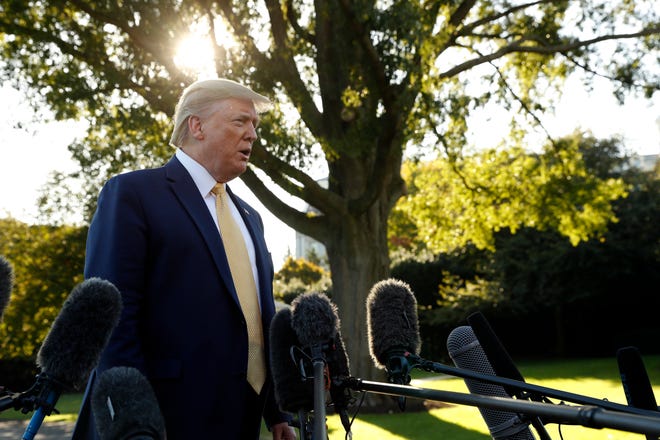 President Donald Trump speaks with reporters on the South Lawn of the White House in Washington on Friday, Oct. 11, 2019, before departing for a campaign rally in Lake Charles, La.