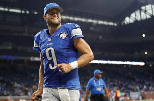 Detroit Lions quarterback Matthew Stafford smiles as he jogs off the field after the game against the Los Angeles Rams at Ford Field. Lions won 31-28.