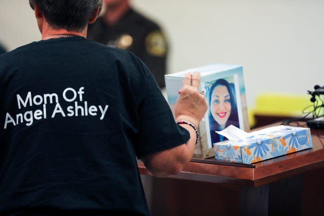 Kristine Young, mother of Ashley Young, gestures to a box containing her daughter's ashes during the sentencing of Jared Chance in Kent County Circuit Court,  Thursday, Oct. 10, 2019, in Grand Rapids, Mich.