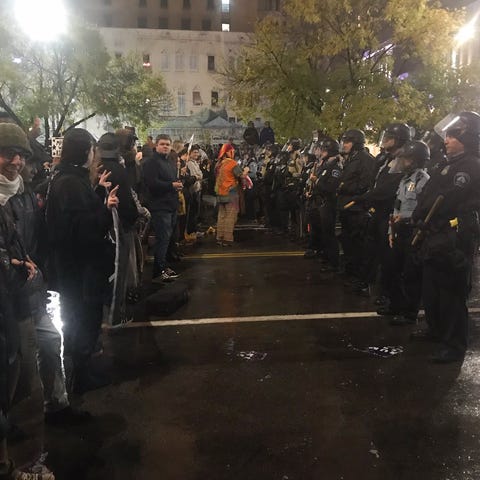 Police face demonstrators Thursday, Oct. 10, 2019 