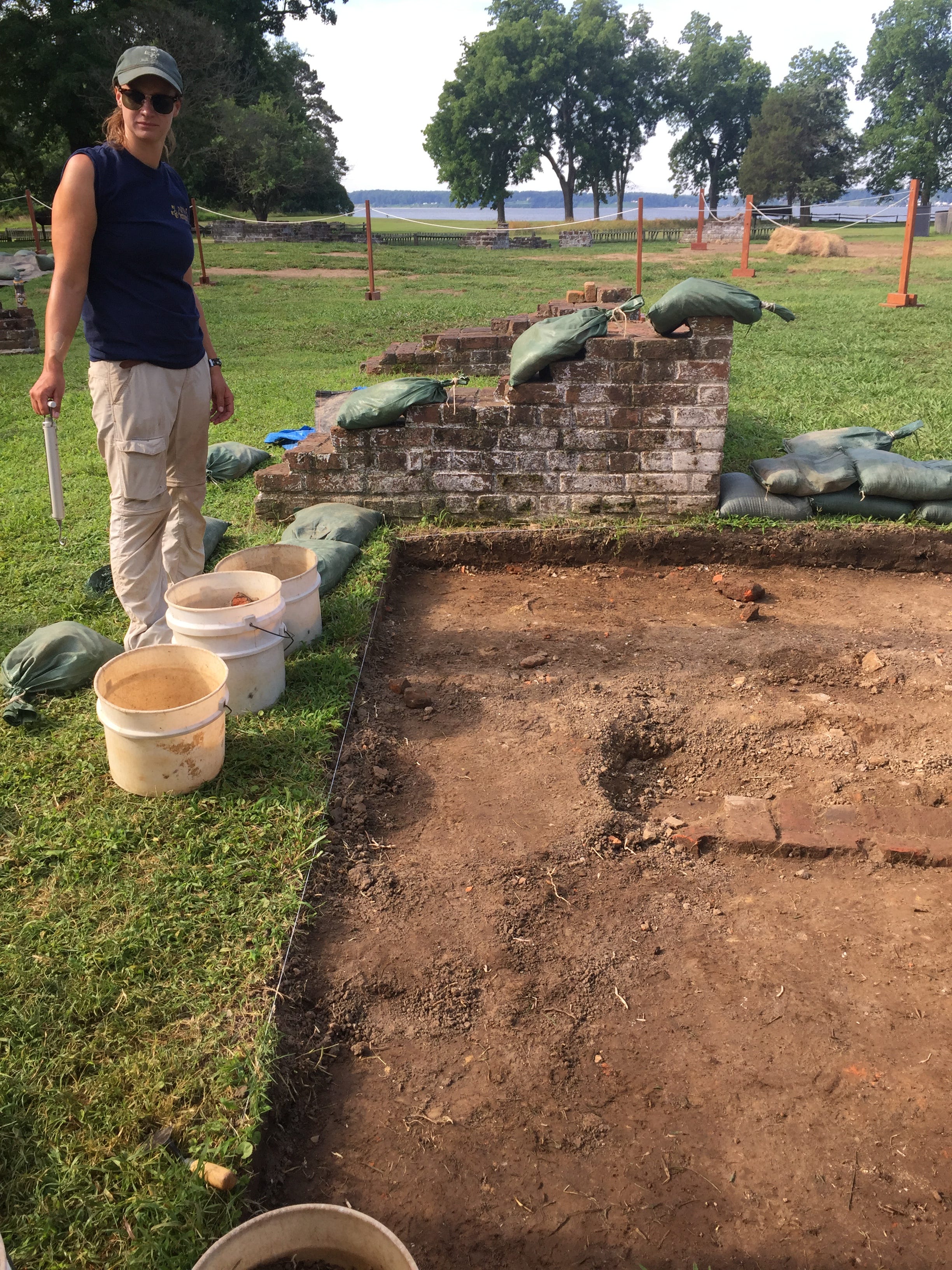 Archaeologist Angelina Towery-Tomasura sorts buckets of dirt and objects from the "Angela" dig site at Historic Jamestowne. She helped find some of the most cherished items, four cowrie shells. The shell's origin is the Indian Ocean, establishing an African presence in Jamestown.