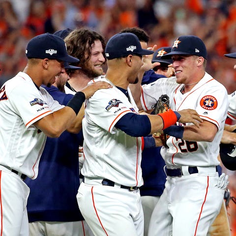 Astros players celebrate the final out.