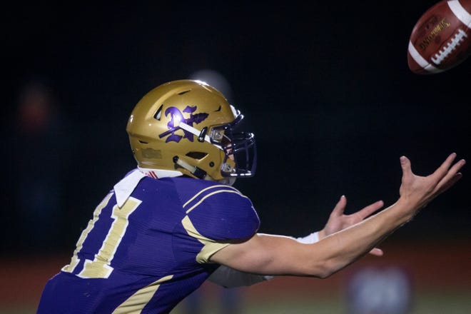 Norwalk's Zach Marker (11) catches a bad snap during their football game on Friday, Oct. 11, 2019 in Norwalk. Norwalk takes a 24-3 lead into halftime.