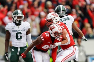 Wisconsin wide receiver Quintez Cephus (87) celebrates a touchdown with teammate Jake Ferguson (84) as Michigan State safety David Dowell (6) and Xavier Henderson react during the first half.
