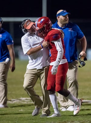 Head coach Jason McDonald congratulates Dacarrion Mcwilliams (5) after making an interception during the West Florida vs Pine Forest football game. The Eagles captured a District 1-5A title on Tuesday with a win at Choctaw.