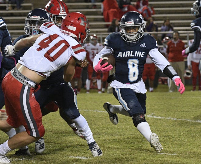 Airline's Jamal Johnson heads around the end as Haughton's Dylan Turner prepares to make the stop.