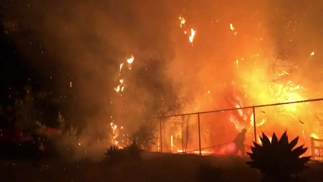 This still from video shows the Ridge View fire in southeast Camarillo late Friday.  Firefighters kept the blaze to a half acre as fire-prone weather conditions lingered in the region.