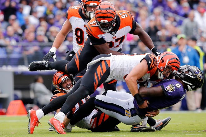 Baltimore Ravens quarterback Lamar Jackson (8) is stopped short of the goal line by Cincinnati Bengals outside linebacker Nick Vigil (59) on a run in the first quarter of the NFL Week 6 game between the Baltimore Ravens and the Cincinnati Bengals at M&T Bank Stadium in Baltimore on Sunday, Oct. 13, 2019.