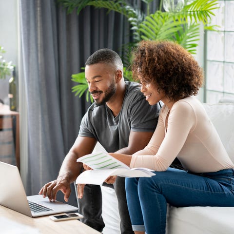 Loving African American couple paying bills online