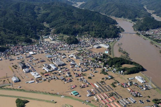This aerial view shows a flooded area beside the Abukuma river in Marumori, Miyagi prefecture on October 13, 2019, one day after Typhoon Hagibis swept through central and eastern Japan.