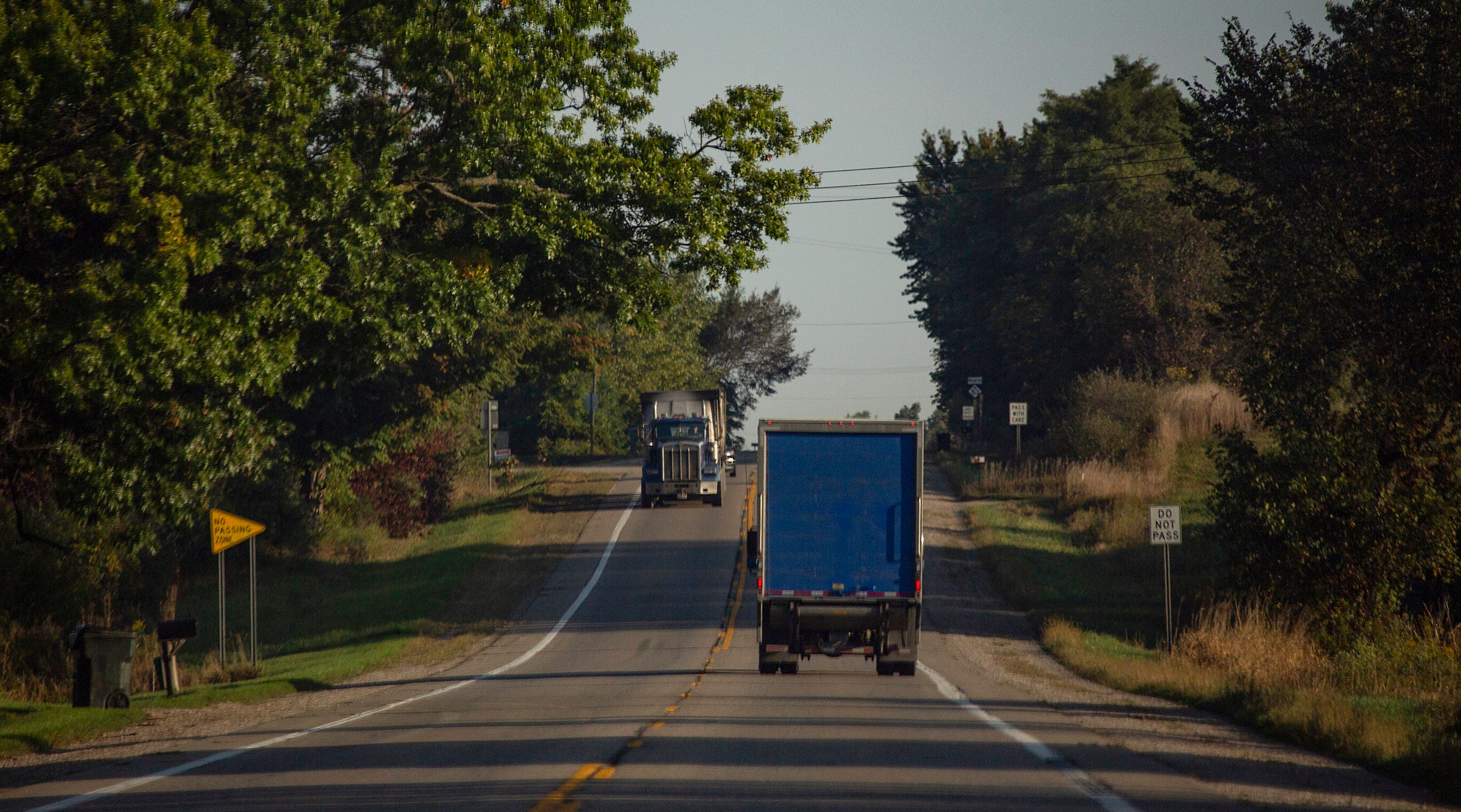 Trucks make their way down a rural Michigan road near Bad Axe.