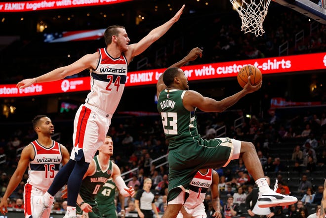 Bucks guard Sterling Brown goes in for a reverse layup against Wizards guard Garrison Mathews during the fourth quarter.