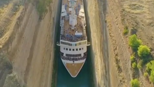 Watch a massive cruise ship squeeze through a narr