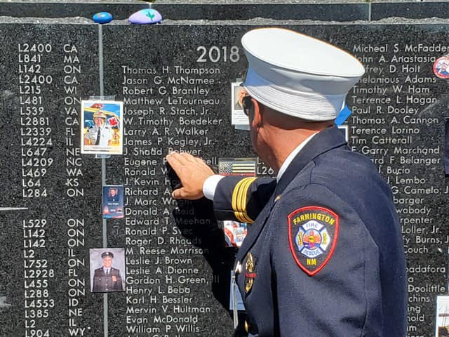 Retired Farmington Fire Department Firefighter Vince Moffit locates the name of Jacob Shadd Rohwer on the  International Association of Firefighters Fallen Fire Fighter Memorial on Sept. 21 in Colorado Springs, Colorado. Rohwer died from job-related cancer. His name was added to the memorial during a ceremony.