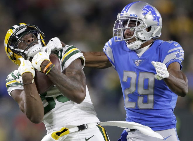 Green Bay Packers wide receiver Marquez Valdes-Scantling (83) makes a reception under the defense of Detroit Lions cornerback Rashaan Melvin (29)  during their football game Monday October 14, 2019, at Lambeau Field in Green Bay, Wis. The packers defeated the Lions 23 to 22.