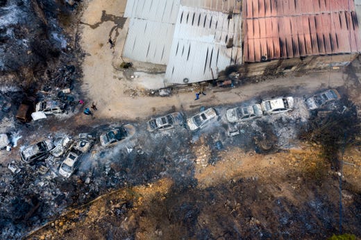 A row of burnt-out cars sit in a line at Al Damour area south Beirut, Lebanon on October 15, 2019. According to reports, 18 Lebanese people were admitted to hospitals for treatment following multiple wildfires that began early on October 14, in Mechref, Dibbiyeh and Al Damour areas at Chouf District in Mount Lebanon.