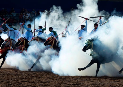 A troupe charges and fire their rifles loaded with gunpowder during a national competition for Tabourida,salon du cheval d'el jadida, in El Jadida, Morocco on October 15, 2019.