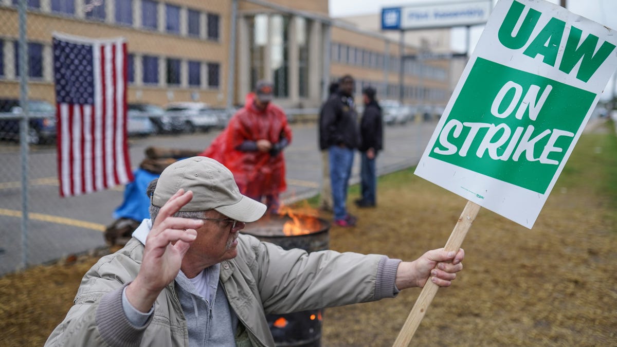 Flint Assembly electrician Mike Thomas sits outside of General Motors Flint Assembly while on strike on Wednesday, October 16, 2019. 