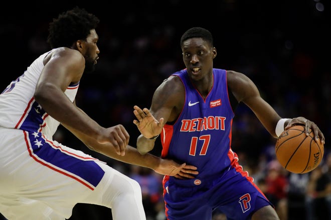 The Pistons' Tony Snell, right, is defended by the 76ers' Joel Embiid during the first half.