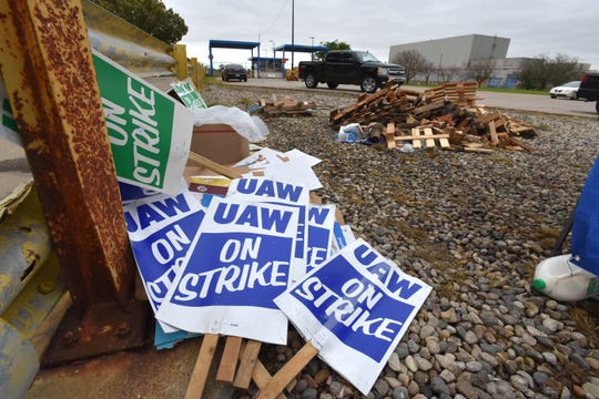 'UAW On Strike' picket signs are stacked up in a pile at the GM Warren Transmission Operations plant before striking UAW members hear there may be a tentative deal.