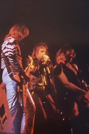 Robert Feest (center) sings during a show. The owner of Robert J Feest & Associates in Elm Grove  used to be a member of the metal band Tease in the Milwaukee area from 1979-83.