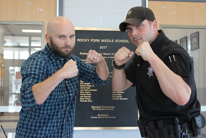 Assistant Principal Alan Davis, left, and SRO Chris Erwin of Rocky Fork Middle School prepare to tangle with professional wrestlers Chris Michaels and Damien Wayne at 7 p.m. Saturday at the school.