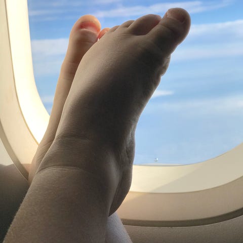 Passenger feet belong inside shoes, not on the wal