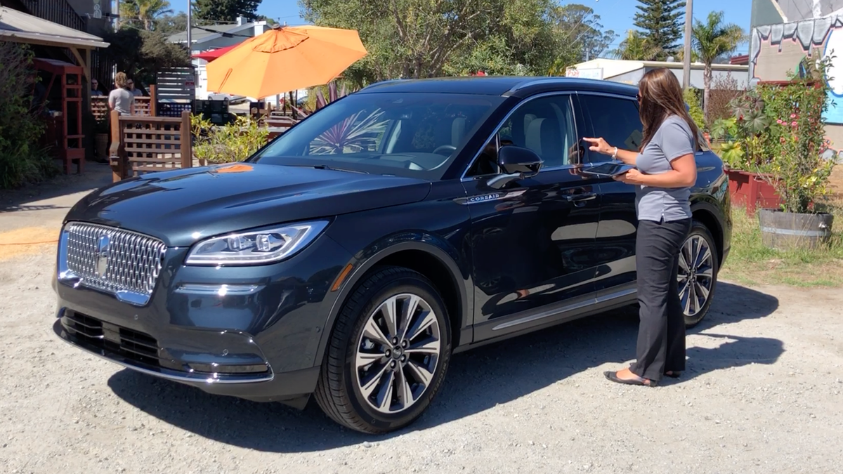 A Ford employee uses the exterior keypad to unlock a 2020 Lincoln Corsair SUV near Carmel, California.