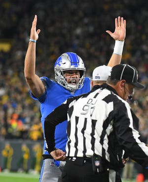 Lions quarterback Matthew Stafford signals for the touchdown, which have been few and far between in the red zone this season.