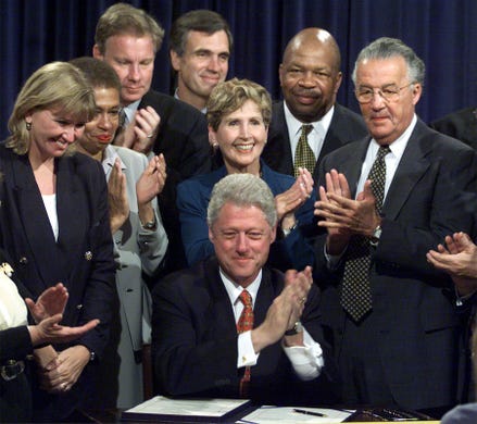 Elijah Cummings and other congress members surround President Clinton after he signed the Long-term Care Security Act on Sept. 19, 2000, in Washington.