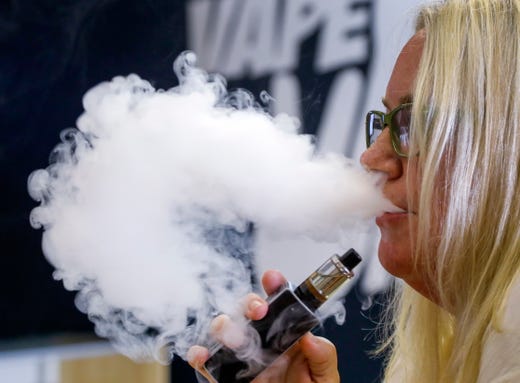 A customer vapes at a store in Avondale Estates, Ga on July 13, 2019.