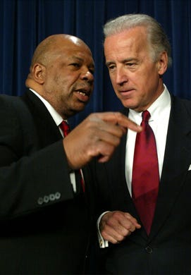 Elijah Cummings speaks with Senator Joseph Biden after a news conference on aid to Africa January 16, 2003 on Capitol Hill in Washington, D.C.