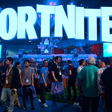 (FILES) In this file photo taken on June 12, 2018, people crowd the display area for the survival game Fortnite at the 24th Electronic Expo, or E3 2018, in Los Angeles, California. - Internet gaming phenomenon Fortnite has temporarily gone offline, leaving millions of addicted gamers wondering what to do with themselves, after a massive asteroid brought the latest season to an end. Epic Games, Fortnite's creators, announced that season ten of the shoot-'em-up   survival video game would end on October 13, 2019 and many users expected season eleven to follow immediately. (Photo by Frederic J. BROWN / AFP) (Photo by FREDERIC J. BROWN/AFP via Getty Images) ORIG FILE ID: AFP_1LE9IL