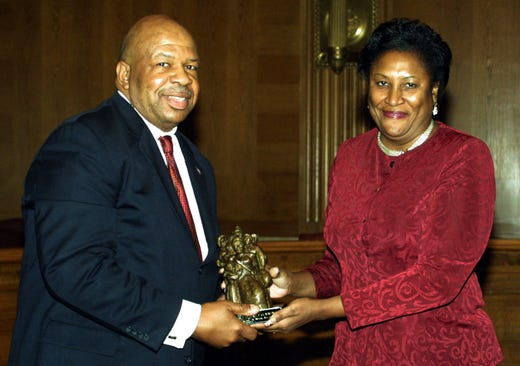 Congressional Black Caucus Chairman Rep. Elijah Cummings, D-Md, left, accepts the Elmer P. Martin Public Service Award from Dr. Joanne M. Martin, co-founder of the Great Blacks and Wax Museum on Nov. 18, 2003, in Washington. Cummings was honored for outstanding contributions to society.