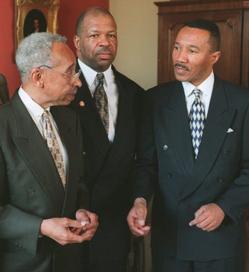Rep. Elijah Cummings, D-MD, is flanked by his predecessor Kweisi Mfume, right, and former Maryland Congressman Parren Mitchell on Capitol Hill Thursday April 25, 1996 after officially being sworn in. Cummings replaced Mfume.