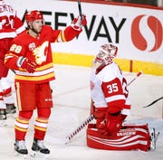 Calgary Flames center Elias Lindholm (28) celebrates his goal in front of Detroit Red Wings goalie Jimmy Howard (35) during second-period NHL hockey action.