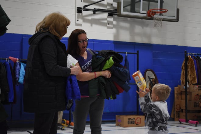 Patty Klamke, pictured left, a member of Women's Auxiliary, and Lindsay Vanmatre browsed for coats Friday for the six children in Lindsay's care.
