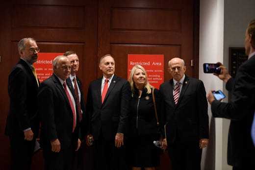 From left, Rep. Andy Harris, R-Md., Rep. Steve King, R-Iowa., Rep. Paul Gosar, R-Ariz., Rep. Andy Biggs, R-Ariz., Rep. Debbie Lesko, R-Ariz., and Rep. Louie Gohmert, R-Texas, pose for a group photo on Capitol Hill in Washington, Oct. 16, 2019, outside the room where people are interviewed for the impeachment inquiry.