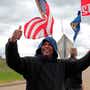 Bill Jackson, of St. Louis, gives a thumbs up to drivers that wave or honk as United Auto Workers outside the GMÂ Wentzville Assembly Center in Wentzville, Mo.,  Wednesday, Oct. 16, 2019. UAW workers have been on strike since Sept. 16, but have reached a tentative deal with GM today. Workers expressed cautious optimism, but will likely remain on the picket line until an official deal has been reached. (Cristina M. Fletes/St. Louis Post-Dispatch via AP)