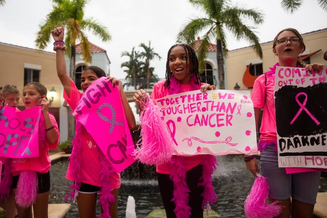 From left to right, Lisa DeLuca, Molly DeLuca, Jaelle Rodriguez, and Olivia Taylor, all members of the Challenger Middle School National Junior Honor Society, cheer for walk participants during the Making Strides Against Breast Cancer walk at Miromar Outlets in Estero on Saturday, October 19, 2019.