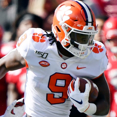 Clemson running back Travis Etienne carries the ba