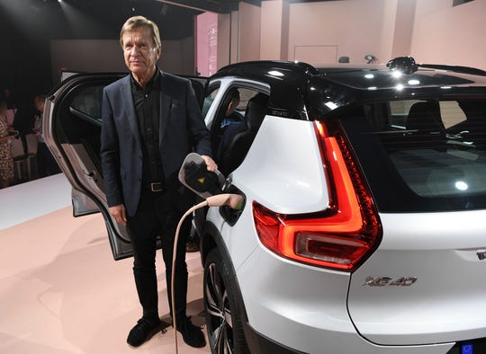 Hakan Samuelsson, President and CEO of Volvo Cars, stands by the electric plug of the XC40 after Volvo Cars revealed its first fully electric car, Wednesday.