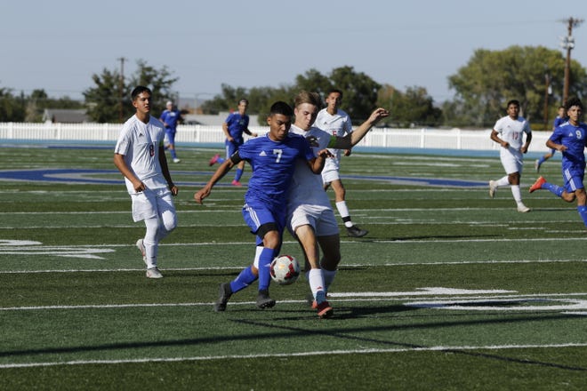 Carlsbad's Louis Ruiz battles a Roswell player in the first half of their match Oct. 19, 2019. Ruiz recorded an assist in the game but Roswell won, 3-1.