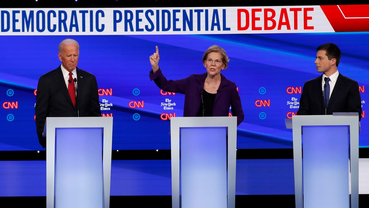 Democratic presidential candidate former Vice President Joe Biden, left, Sen. Elizabeth Warren, D-Mass., and South Bend Mayor Pete Buttigieg, right, participate in a Democratic presidential primary debate hosted by CNN/New York Times at Otterbein University, Tuesday, Oct. 15, 2019, in Westerville, Ohio. (AP Photo/John Minchillo)